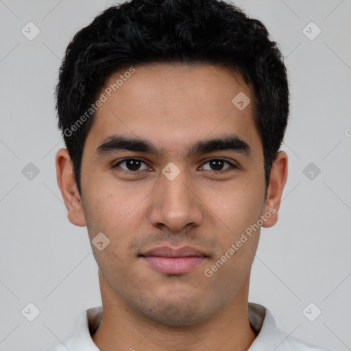 Joyful latino young-adult male with short  black hair and brown eyes