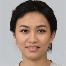 Joyful asian young-adult female with medium  brown hair and brown eyes