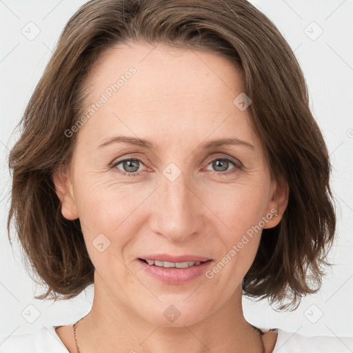 Joyful white adult female with medium  brown hair and grey eyes