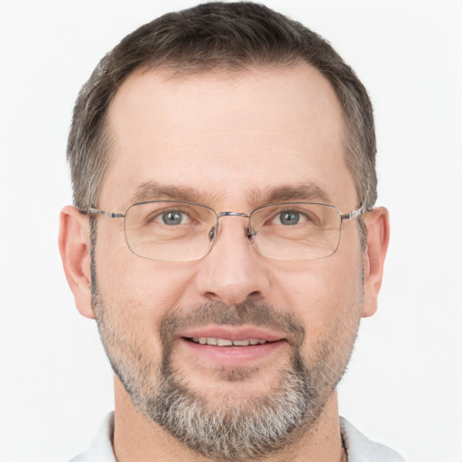 Joyful white adult male with short  brown hair and brown eyes