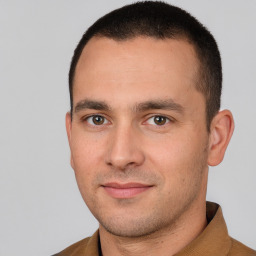 Joyful white young-adult male with short  brown hair and brown eyes