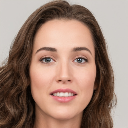 Joyful white young-adult female with long  brown hair and green eyes