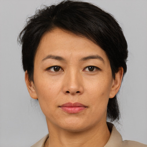 Neutral asian adult female with short  black hair and brown eyes