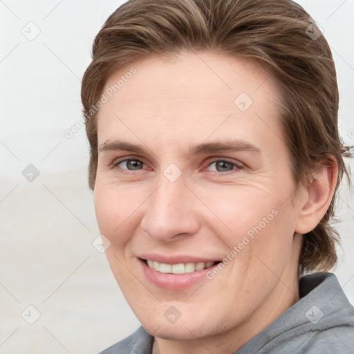 Joyful white young-adult female with short  brown hair and grey eyes