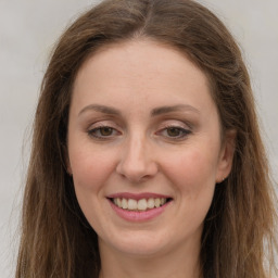 Joyful white young-adult female with long  brown hair and green eyes