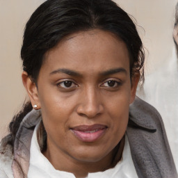 Joyful black adult female with medium  brown hair and brown eyes