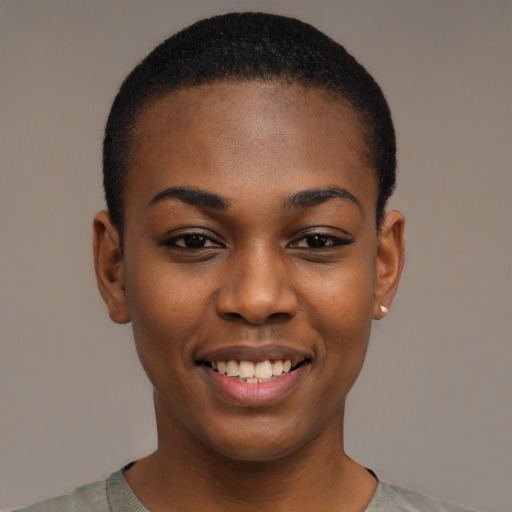 Joyful black young-adult female with short  black hair and brown eyes