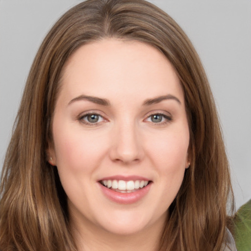 Joyful white young-adult female with long  brown hair and grey eyes