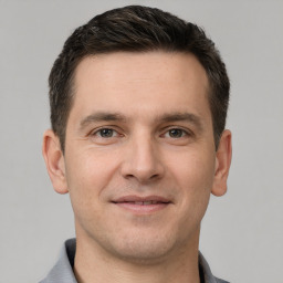 Joyful white young-adult male with short  brown hair and brown eyes