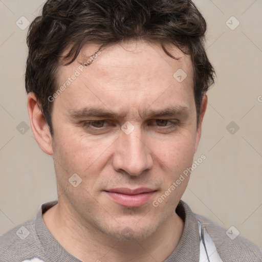 Joyful white adult male with short  brown hair and grey eyes