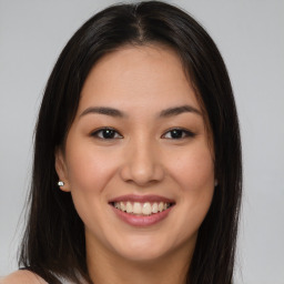 Joyful asian young-adult female with long  brown hair and brown eyes