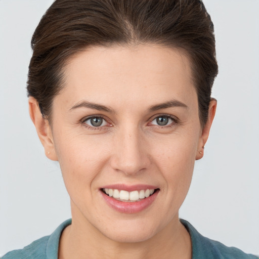 Joyful white young-adult female with short  brown hair and brown eyes