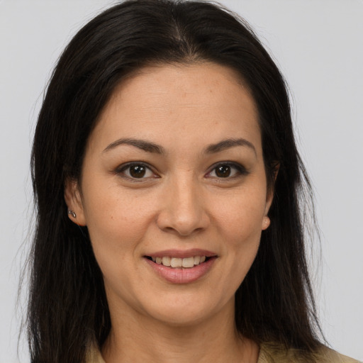 Joyful latino young-adult female with long  brown hair and brown eyes