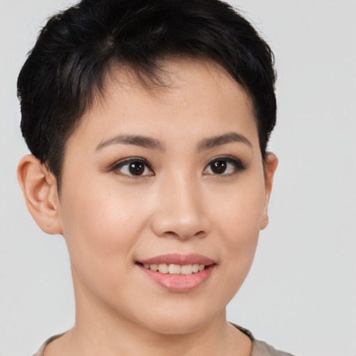 Joyful asian young-adult female with short  brown hair and brown eyes