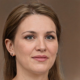 Joyful white adult female with long  brown hair and grey eyes