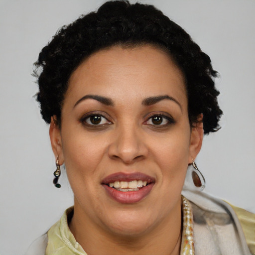 Joyful latino adult female with short  black hair and brown eyes