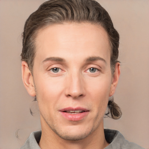 Joyful white adult male with short  brown hair and grey eyes