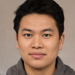 Joyful asian young-adult male with short  black hair and brown eyes