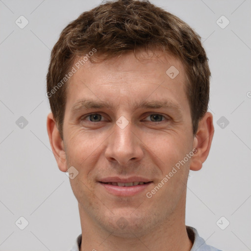 Joyful white adult male with short  brown hair and grey eyes