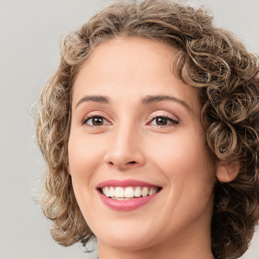 Joyful white young-adult female with medium  brown hair and green eyes