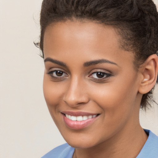 Joyful latino young-adult female with short  brown hair and brown eyes