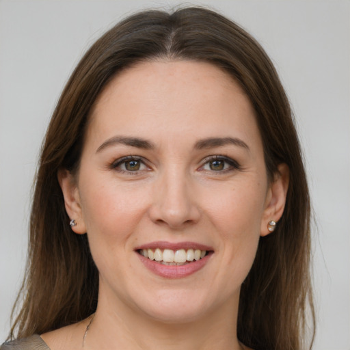 Joyful white young-adult female with medium  brown hair and grey eyes