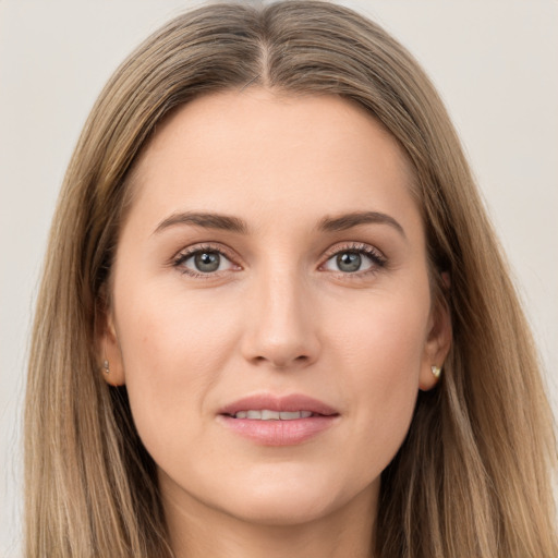 Joyful white young-adult female with long  brown hair and grey eyes