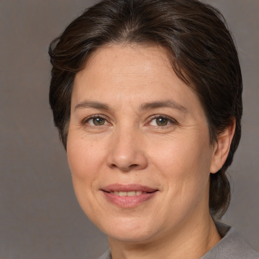 Joyful white adult female with medium  brown hair and brown eyes