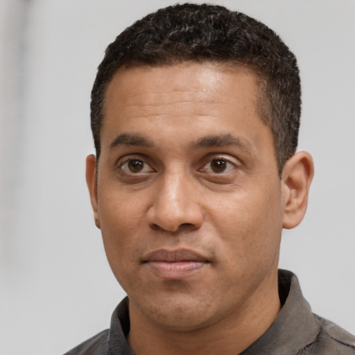 Neutral black young-adult male with short  black hair and brown eyes