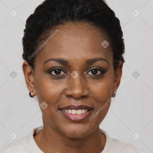 Joyful black young-adult female with short  black hair and brown eyes