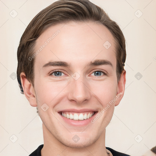 Joyful white young-adult male with short  brown hair and grey eyes