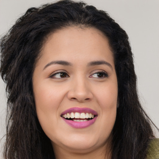 Joyful latino young-adult female with long  black hair and brown eyes