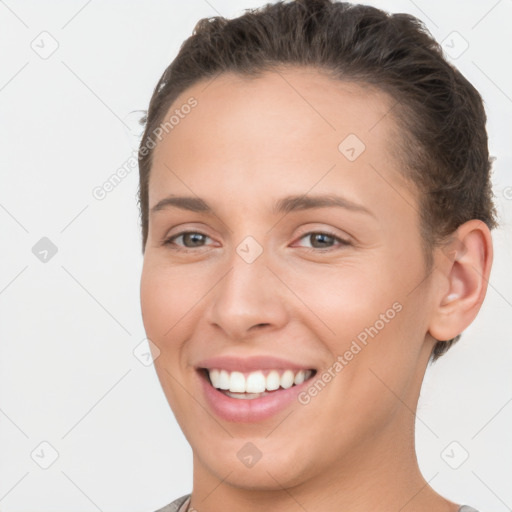 Joyful white young-adult female with short  brown hair and brown eyes