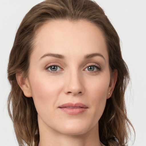 Joyful white young-adult female with long  brown hair and grey eyes