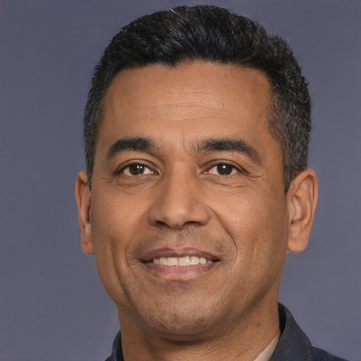 Joyful white adult male with short  black hair and brown eyes