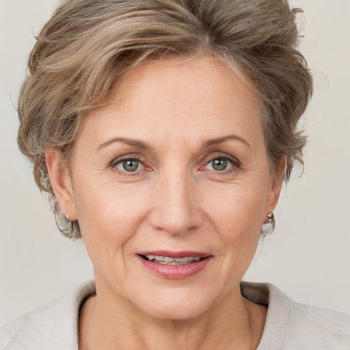 Joyful white adult female with short  brown hair and grey eyes