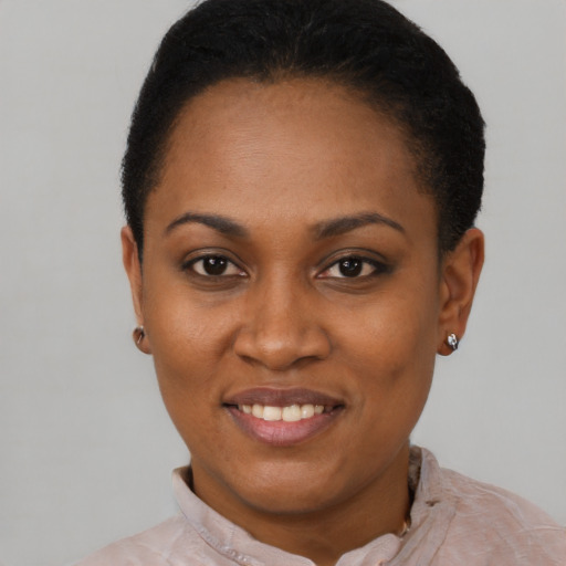 Joyful black young-adult female with short  black hair and brown eyes