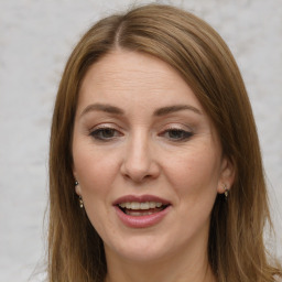 Joyful white adult female with long  brown hair and brown eyes