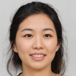 Joyful asian young-adult female with medium  brown hair and brown eyes