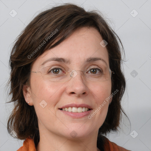 Joyful white adult female with medium  brown hair and blue eyes