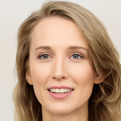 Joyful white young-adult female with long  brown hair and green eyes