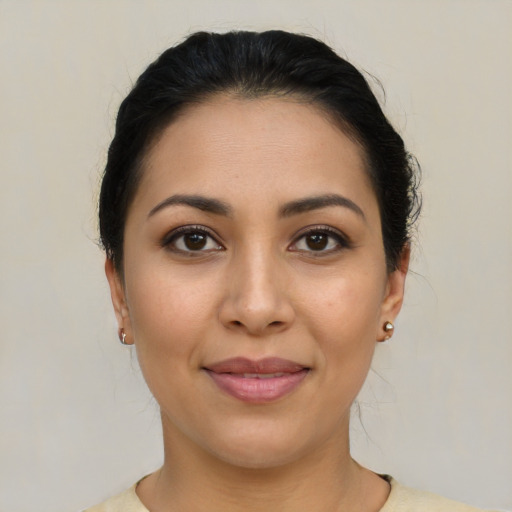 Joyful latino young-adult female with medium  brown hair and brown eyes
