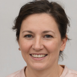 Joyful white adult female with medium  brown hair and brown eyes