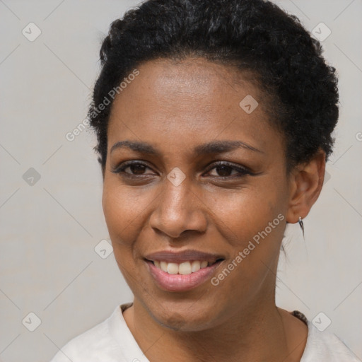 Joyful black young-adult female with short  brown hair and brown eyes