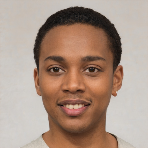 Joyful black young-adult male with short  black hair and brown eyes