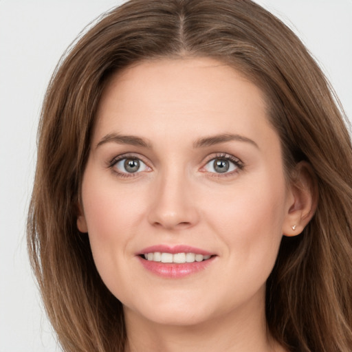 Joyful white young-adult female with long  brown hair and grey eyes