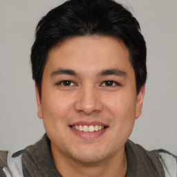 Joyful asian young-adult male with short  brown hair and brown eyes