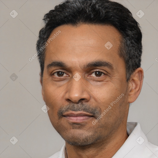Neutral latino adult male with short  black hair and brown eyes