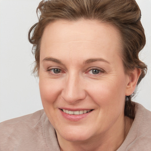 Joyful white adult female with medium  brown hair and brown eyes