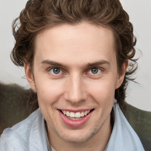 Joyful white young-adult male with medium  brown hair and brown eyes